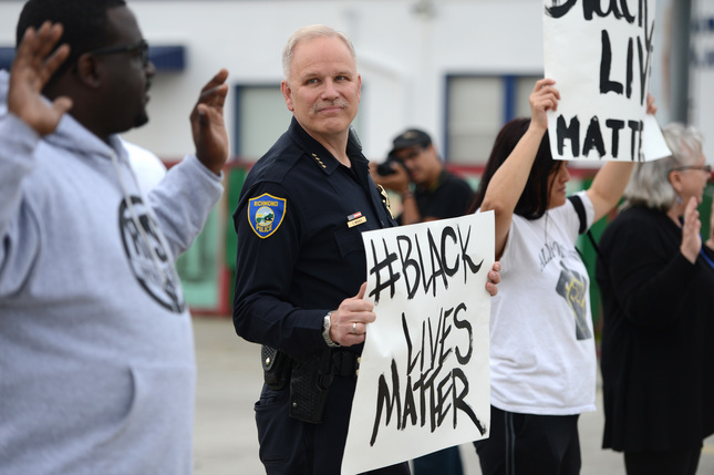 Richmond police Chief Chris Magnus stands with demonstrators along Macdonald Avenue to protest the Michael Brown and Eric Garner deaths during a peaceful